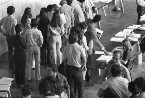Crowd of Students Waiting in Line by Registration Tables