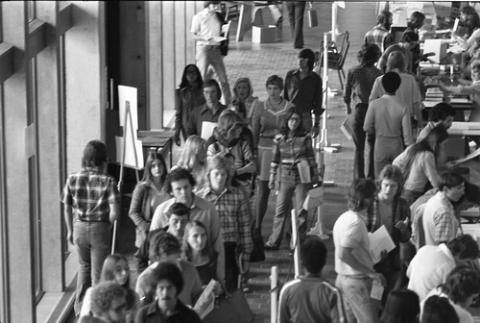 Crowd of Students in Hallway with Registration Tables