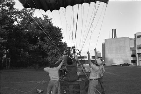 People Holding Wiring of Hot Air Balloon