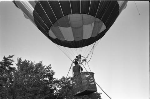 Person in Hot Air Balloon Above a Field