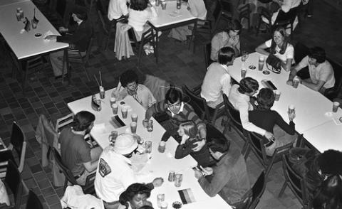 Students Seated at Tables with German Flags in The Meeting Place