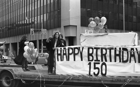 Students on Homecoming Float with Sign Reading 'Happy Birthday 150'