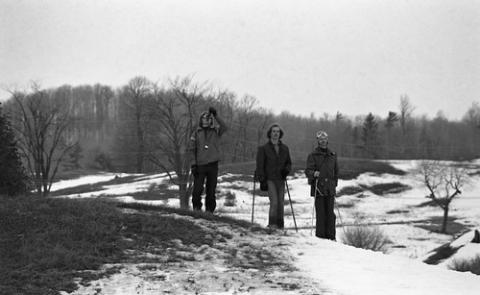 Three Students Standing on Hill With Ski Poles