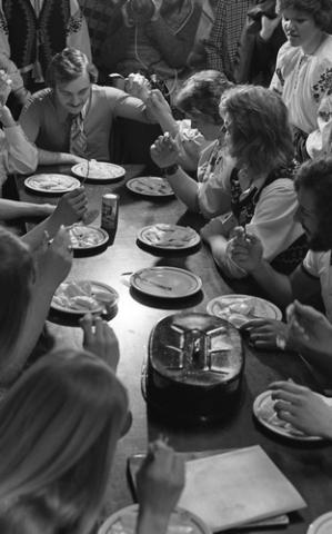 Students Seated and Standing at Table with Pierogies