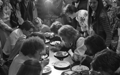 Students Seated and Standing at Table with Pierogies