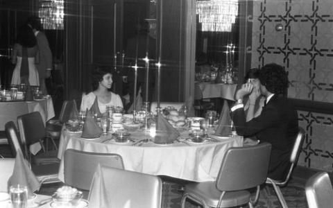 Three Students in Formal Wear Seated at Table