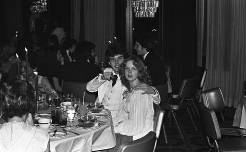 Two Students in Formal Wear Seated at Dining Table