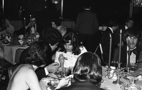 Group of Students in Formal Wear Seated at Dining Table