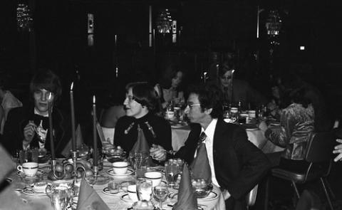 Group of Students in Formal Wear Seated at Dining Table