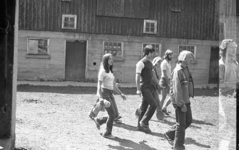 Group of Students Walking Past Stables