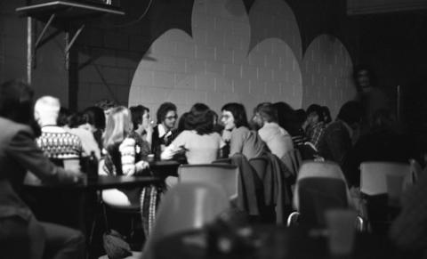 Group of Students Seated at Table in College Pub