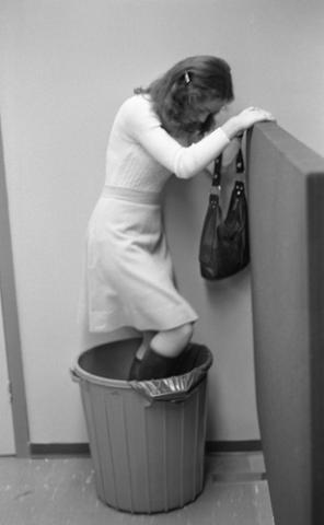 Student Standing in Garbage Bin