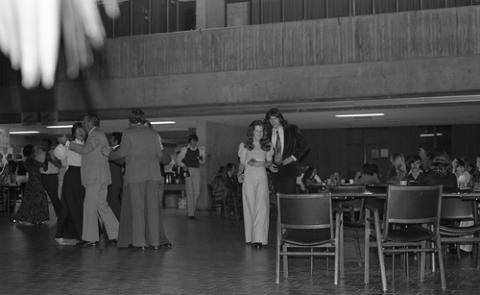 Two Students Walking Across Edge of Dance Floor in The Meeting Place