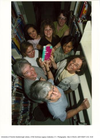 Library staff holding last book to be kept in Bladen Library, Scarborough College